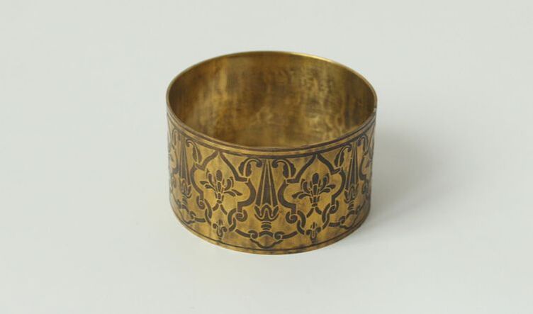 Bracelet made of brass with an Indian ornament etched onto it.
